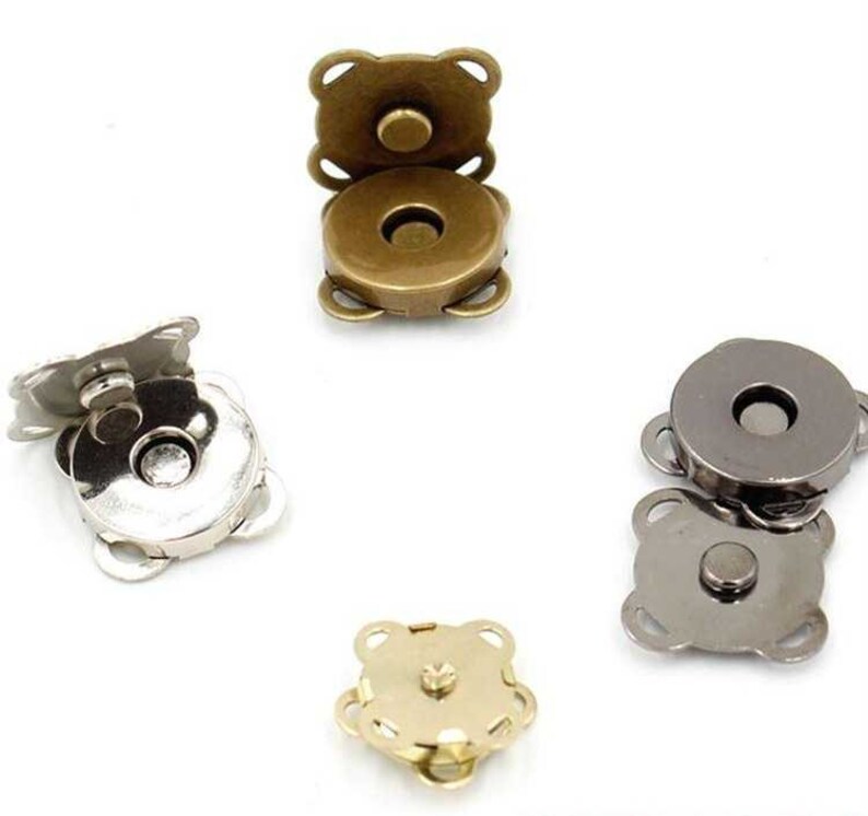 May include: Four magnetic snap closures in different finishes: gold, silver, and gunmetal. Each closure has a round button and four prongs.