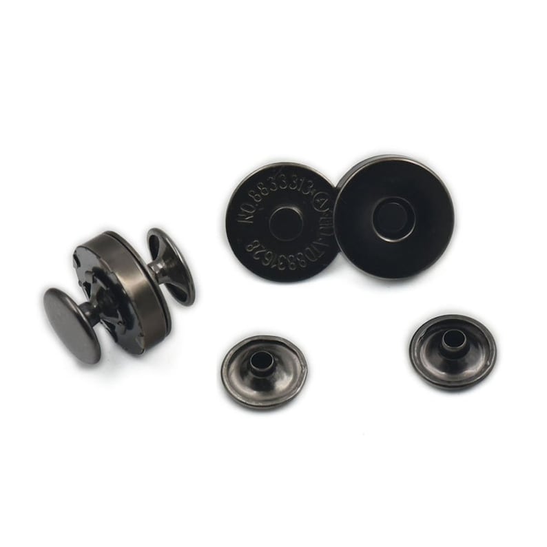 May include: A selection of dark grey magnetic snap closures, suitable for bags or craft projects. The set includes two circular pieces with the text "NO.8833313" and two smaller, flat pieces. One assembled snap is also visible.