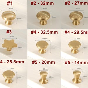 May include: Assortment of ten gold cabinet knobs in various styles and sizes. The knobs are arranged in three rows of three. The knobs are all made of brass and have a polished finish. The knobs are labeled with numbers and measurements in inches.