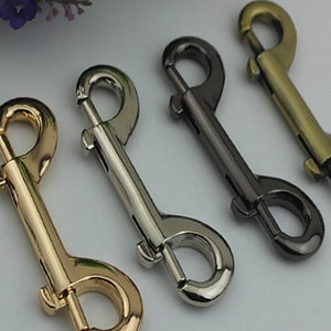 May include: Four metal swivel snap hooks in gold, silver, and black.