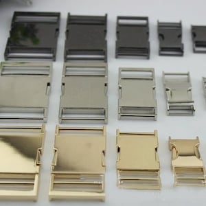 May include: Assortment of metal slider buckles in various sizes and finishes, including silver, gold, and black. The buckles are ideal for crafting projects, such as making dog collars, belts, and straps.