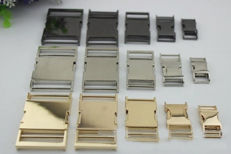 May include: Assortment of metal slider buckles in various sizes and finishes, including silver, gold, and black. The buckles are ideal for crafting projects, such as making dog collars, belts, and straps.