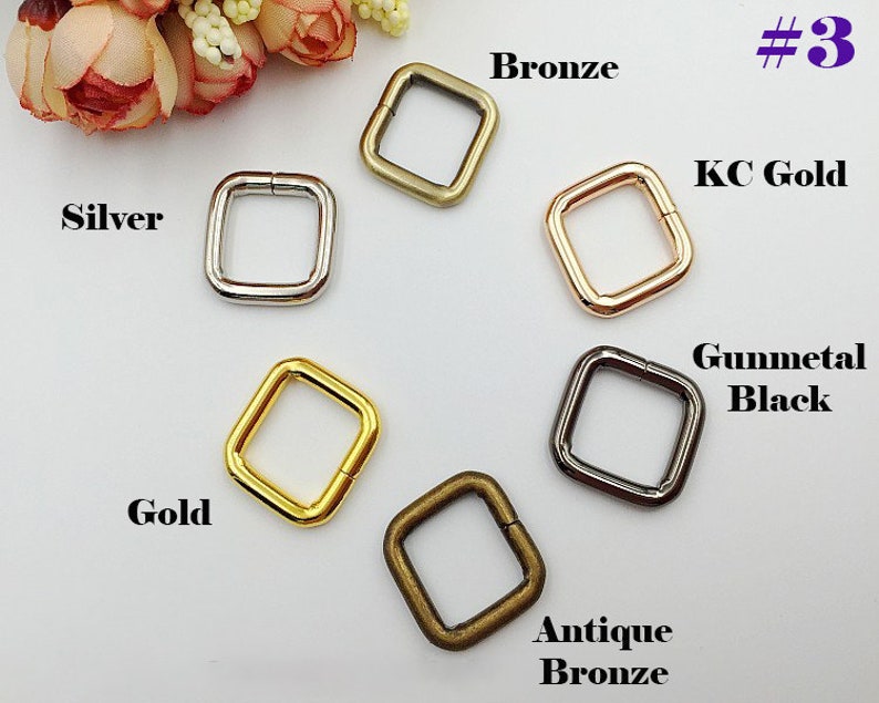 May include: Six square-shaped metal rings in different finishes: silver, gold, bronze, antique bronze, gunmetal black, and KC gold. #3