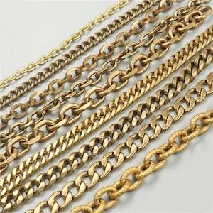 May include: A selection of gold-coloured metal chains, featuring diverse styles and link sizes. The chains are arranged diagonally, displaying various textures and designs, ranging from fine to bold.