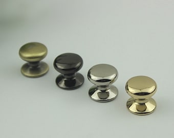 May include: Four cabinet knobs in different finishes: antique brass, black, nickel, and gold.