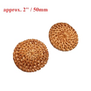 May include: Two round, woven, natural-colored rattan or wicker buttons, each measuring approximately 2 inches in diameter.  The buttons have a woven pattern and are perfect for adding a touch of natural texture to crafts and home decor projects.