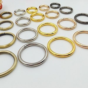 May include: Assortment of metal rings in various sizes and finishes, including gold, silver, bronze, and black. The rings are ideal for crafting, jewelry making, and other DIY projects.