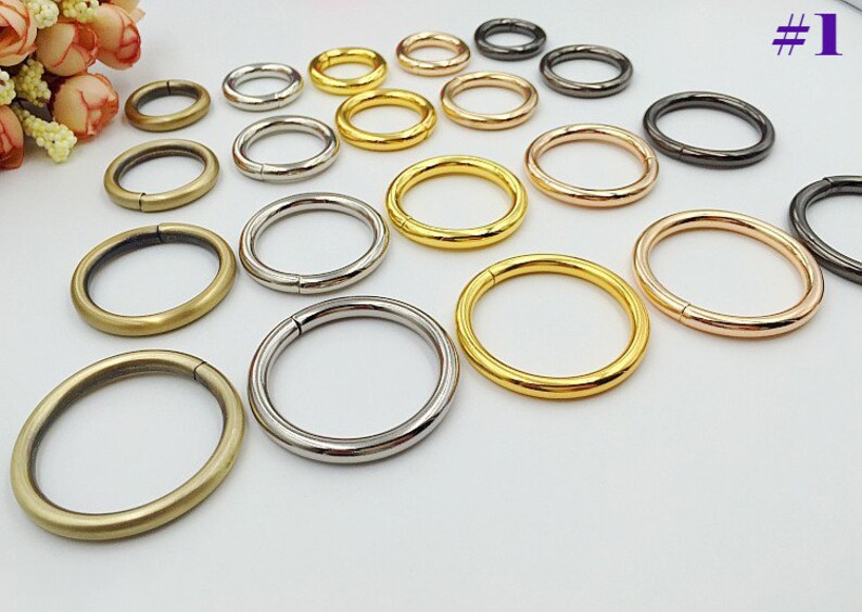May include: Assortment of metal rings in various sizes and finishes, including gold, silver, bronze, and black. The rings are ideal for crafting, jewelry making, and other DIY projects.