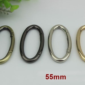 May include: Four oval-shaped metal swivel clasps in gold, silver, black, and antique gold. Each clasp measures 55mm in length.