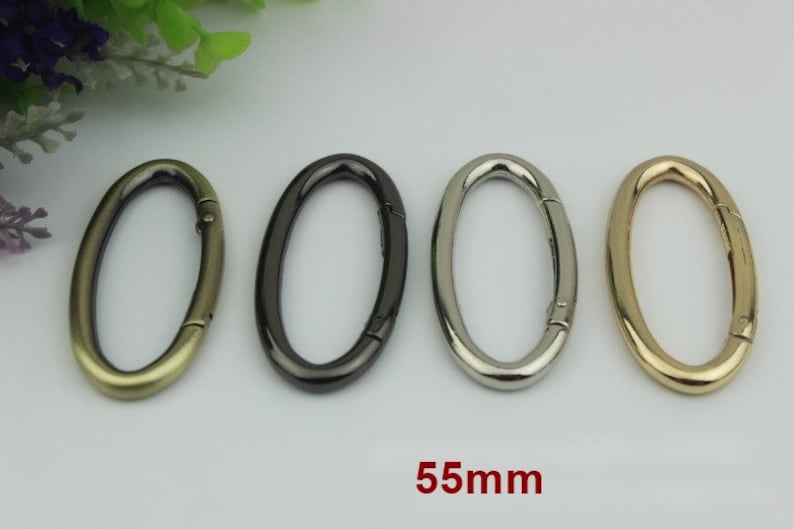 May include: Four oval-shaped metal swivel clasps in gold, silver, black, and antique gold. Each clasp measures 55mm in length.