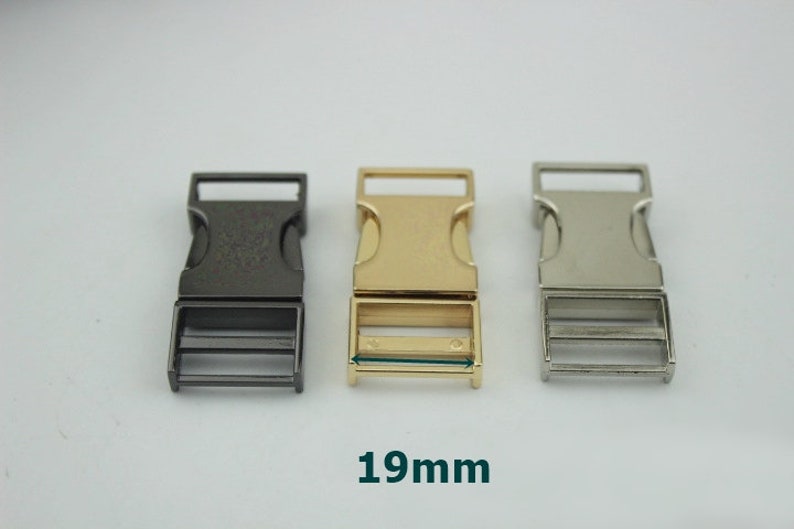 May include: Three plastic buckle closures in black, gold, and silver. Each buckle measures 19 mm in width.