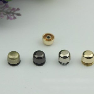 May include: Five metal dome-shaped studs in different finishes: gold, silver, antique brass, black nickel, and antique silver.