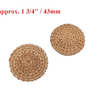 May include: Two round, woven, natural-colored wicker or rattan coasters, each measuring approximately 1 3/4 inches in diameter.