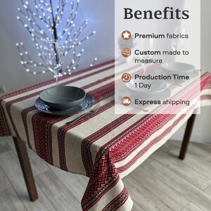 May include: A red and white striped tablecloth with a geometric pattern. The tablecloth is made of linen and is perfect for a farmhouse or rustic style table setting.