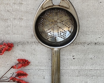 Antique metal tea strainer