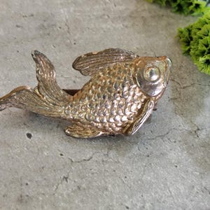 gold coloured fish brooch