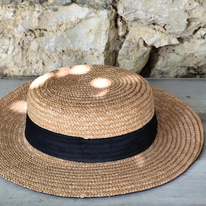 old straw hat with black ribbon