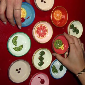 May include: A set of three ceramic mugs with a speckled, matte finish. The mugs are in shades of cream, light gray, and dark gray. Each mug has a simple, minimalist design, perfect for coffee or tea.