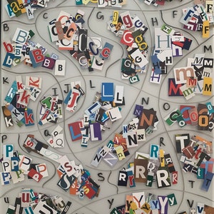 May include: A white board with the words "MAGAZINE LETTERS" written at the top. The board is divided into sections, each containing a different letter of the alphabet. The letters are made of cut-out magazine letters, creating a colorful and textured display.