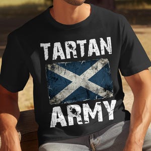 Black t-shirt with distressed Scottish flag and "TARTAN ARMY" text.