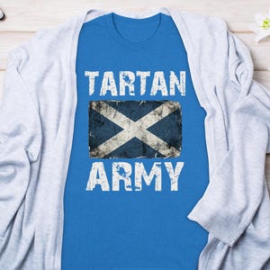 Blue t-shirt with distressed Scottish flag and "TARTAN ARMY" text.