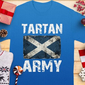 Blue t-shirt with white "TARTAN ARMY" text and a distressed Scottish flag graphic.