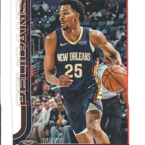 May include: A basketball trading card featuring Trey Murphy III of the New Orleans Pelicans. The card shows Murphy in a navy blue jersey with the number 25, dribbling a basketball. The card has the Pelicans logo and team name.