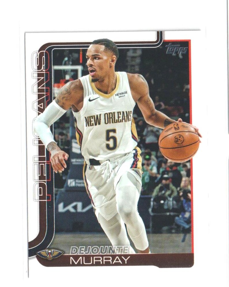 May include: A Topps trading card featuring Dejounte Murray of the New Orleans Pelicans. Murray is wearing a white jersey with the number 5 and the words "New Orleans" across the chest. He is dribbling a basketball. The card has a brown border.