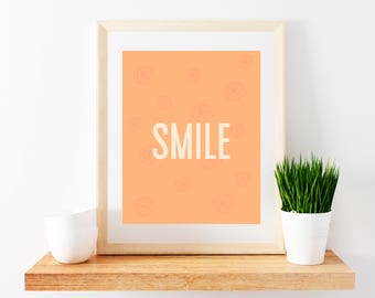 May include: A framed print with a peach background and a white outline of a flower pattern. The word "SMILE" is written in white letters in the center of the print.