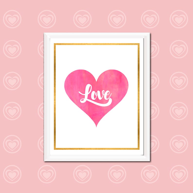 May include: A white frame with a gold border, containing a pink watercolor heart with the word "Love" written in white inside. The frame is against a pink background with a pattern of white hearts.