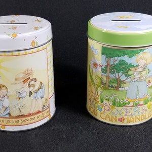 2 Mary Engelbreit Metal Coin Banks, Set of 2  "All The Happiness You Can Handle" "The Great End of Life is Not Knowledge But Action"