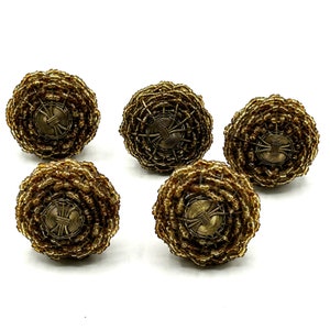 May include: Set of five gold-toned beaded curtain tiebacks. Each tieback features a circular design with a woven wire center.