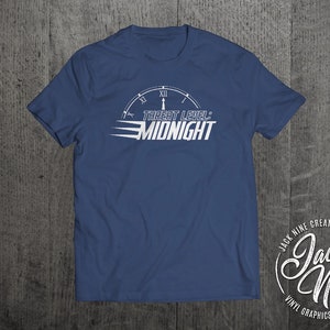 May include: A navy blue t-shirt with a white graphic of a clock face with the text "Threat Level: Midnight". The graphic is stylized to look like a speedometer. The shirt is a men's size large.