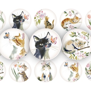 May include: A collection of round decorative objects featuring watercolor illustrations of cats. The cats are depicted in various poses, interacting with butterflies and flowers. The color palette includes soft pastels and earth tones, creating a whimsical and artistic aesthetic.