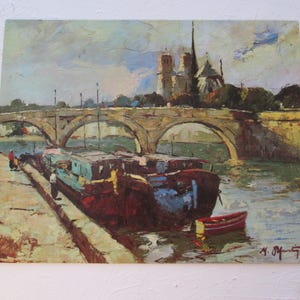 May include: A painting of a bridge over a river with boats docked on the left side of the bridge. The Notre Dame Cathedral is visible in the background. The painting is done in a style reminiscent of impressionism.