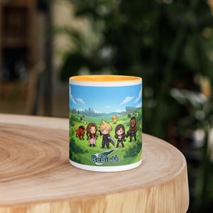 Könnte beinhalten: Ein weißer Keramikbecher mit gelbem Innenraum, der eine farbenfrohe Grafik von Chibi-Videospielcharakteren in einer grünen Landschaft zeigt. Der Schriftzug "Rebirth" ist in einer stilisierten Schriftart unten mittig abgebildet.