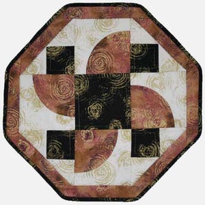 May include: Octagonal table runner with a geometric design featuring black, brown, and white fabric with a swirling pattern.