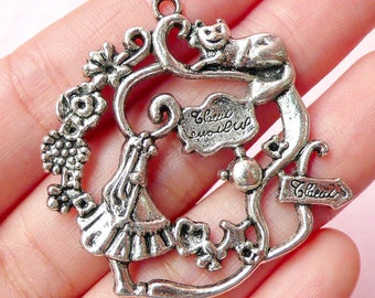 a silver pendant, alice in Wonderland