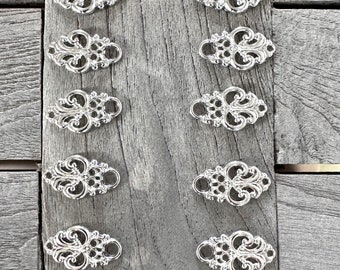 10 Pezzi Argento Glanzend Miederösen in Metallo per Dirndl Tracht 25mmx15mm