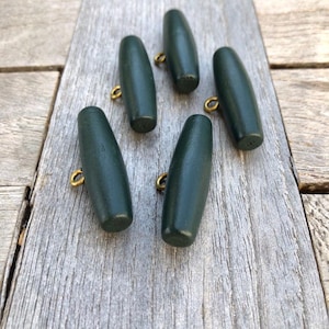 May include: Six dark green wooden toggle buttons with gold metal loops.