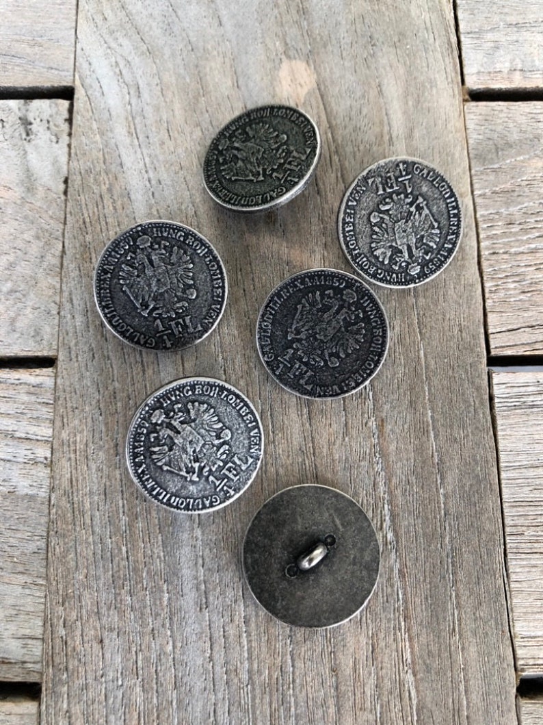 May include: Five silver-toned buttons with raised designs. The buttons feature a two-headed eagle with the text "GALLON" and "HUNG BOR LOMBEI VEN" around the eagle. One button has the text "FL" on it.