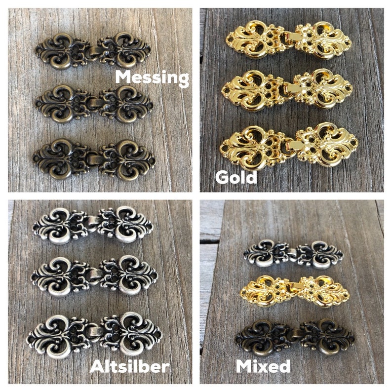May include: Three sets of decorative metal clasps in various finishes: gold, silver, and mixed. Each set includes two clasps with an ornate design.