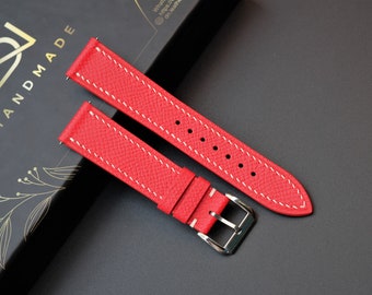 May include: Red leather watch strap with white stitching. The strap is shown on a black background with a box that says "Handmade".