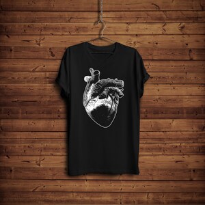 May include: Black t-shirt with a white anatomical heart graphic print.