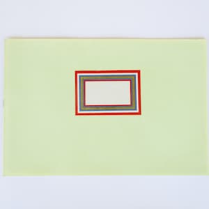 May include: A light green card with a rectangular label in the center. The label has a white background and is surrounded by four frames in red, blue, gold, and green.