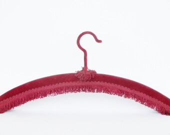 Antique burgundy velvet clothes hanger with fringed edge. Clothing. Home accessory. Collectible. Cintre en velours bordeaux
