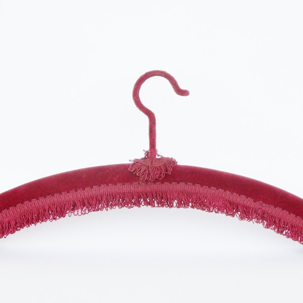 Antique burgundy velvet clothes hanger with fringed edge. Clothing. Home accessory. Collectible. Cintre en velours bordeaux