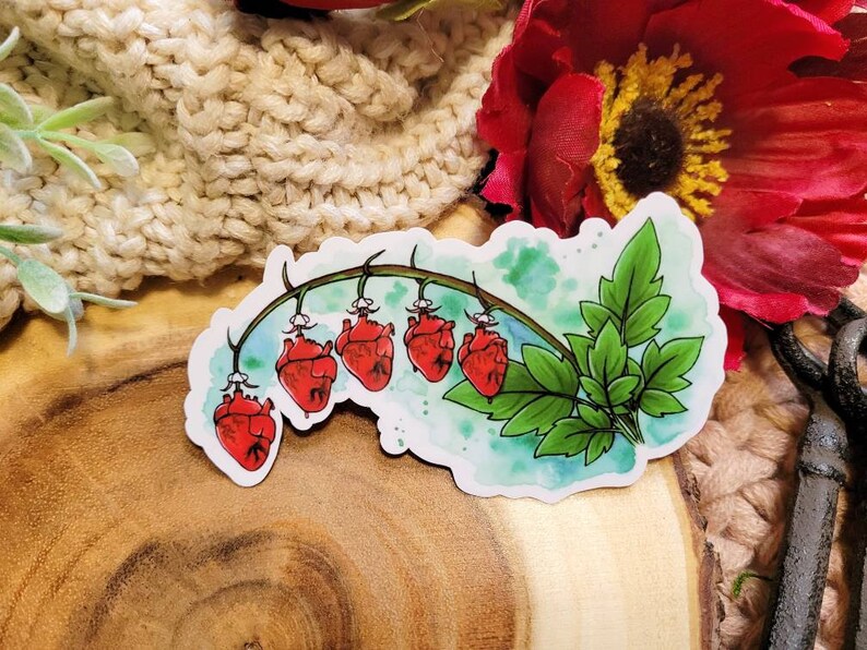 May include: A sticker featuring a watercolor illustration of a vine with five red hearts hanging from it. The vine has green leaves and is set against a blue and white watercolor background.