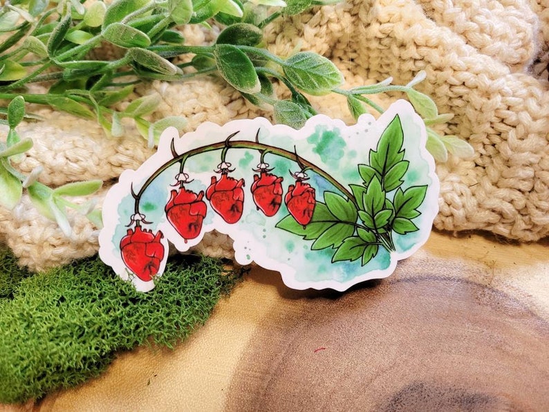 May include: A sticker featuring a watercolor illustration of a vine with five red heart-shaped flowers. The vine is green and has leaves. The background is a light blue watercolor wash.