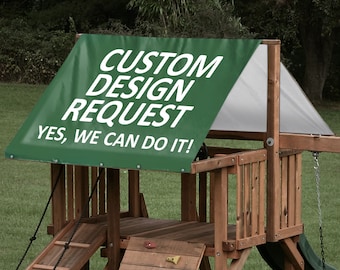 May include: Green canopy with white text that reads "CUSTOM DESIGN REQUEST YES, WE CAN DO IT!"  The canopy is attached to a wooden playset with a slide, ladder, and climbing wall.